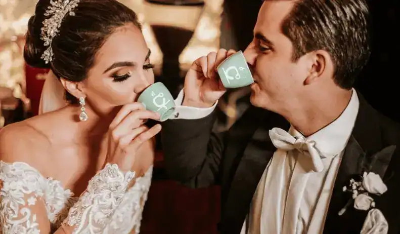 Bride and groom holding personalized coffee cups at their Miami wedding